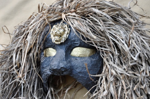 One of my more creepy creations, made from papier mâché, lily leaves, gold paper and a lion pendant.